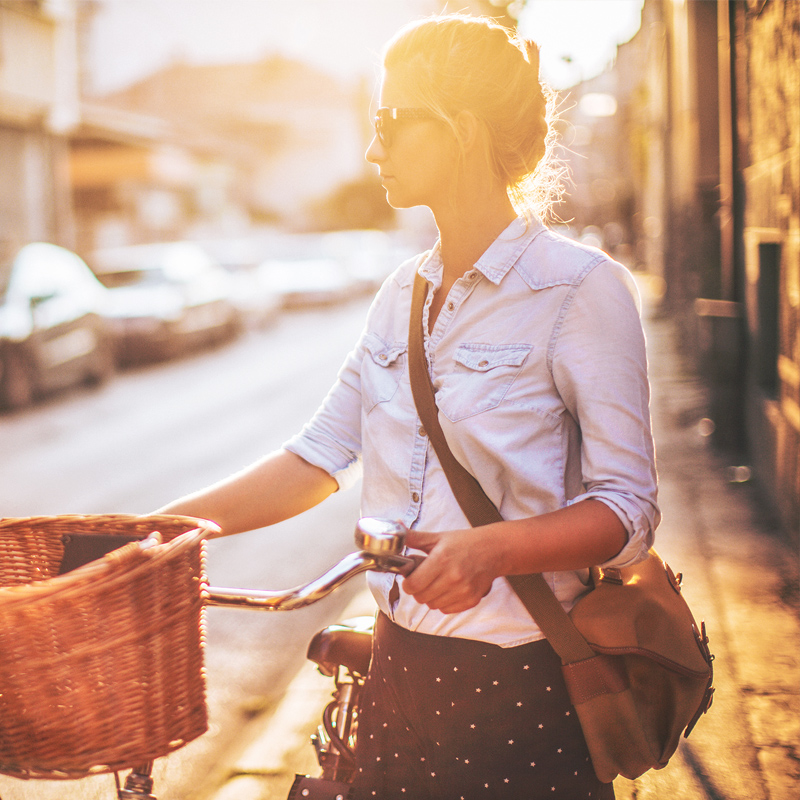 Image of a women pushing a bicycle