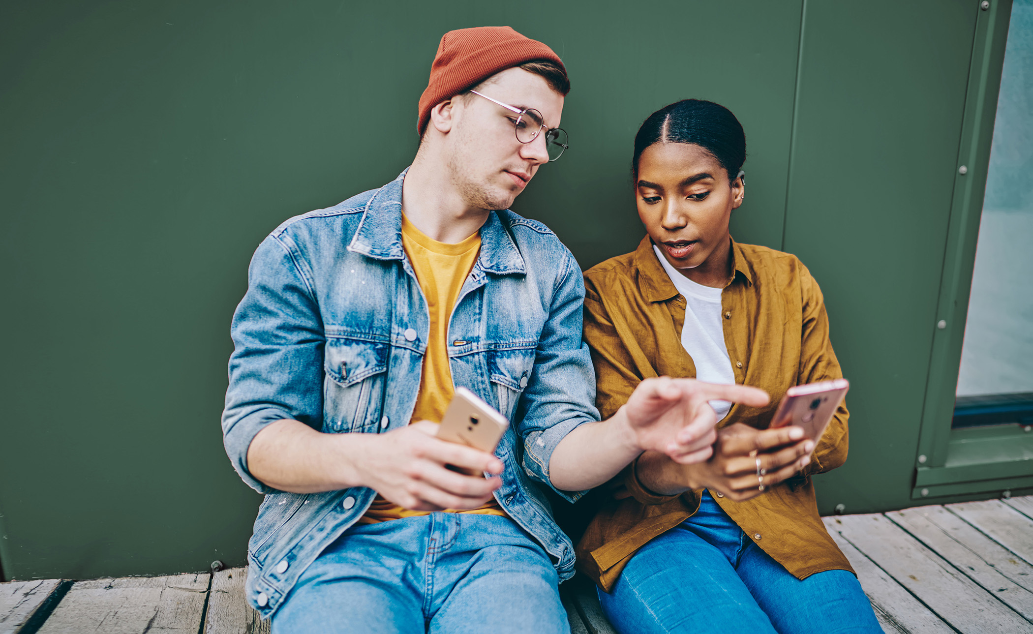 Young man and women looking at phones
